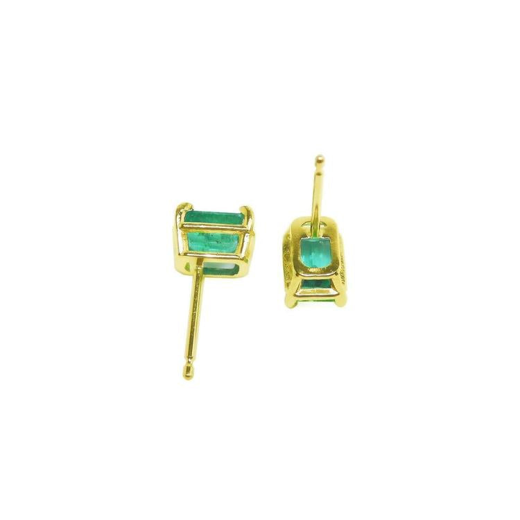 Emerald-cut natural Colombian emerald stud earrings, 1.29 ct, set in 14K yellow gold basket settings.