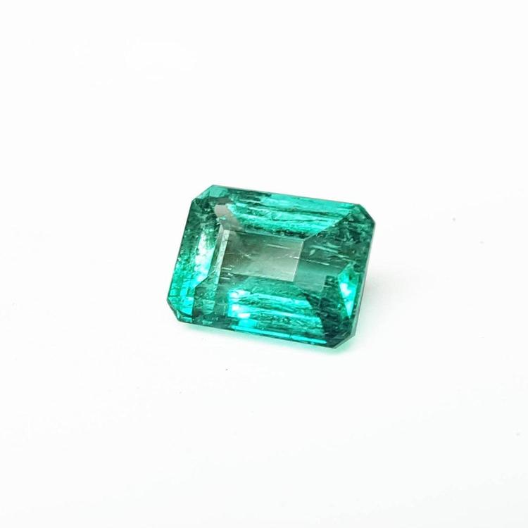 Affordable emerald-cut loose Colombian emerald front left side table and crown view