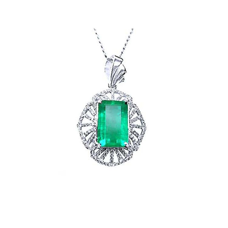 Emerald-cut natural colombian emerald pendant with white gold chain on a topside view position.