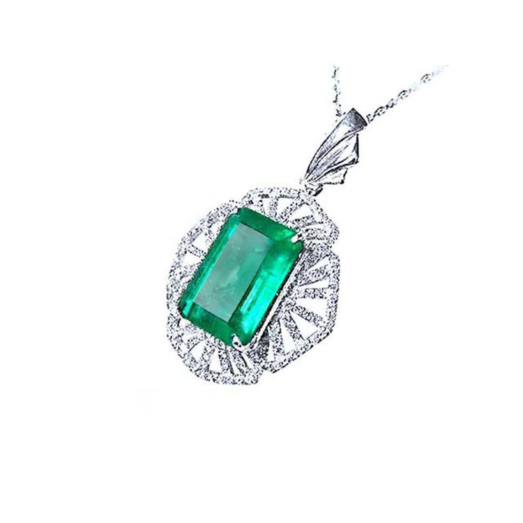 Emerald green gemstone pendant on a white gold chain, topside perspective view.