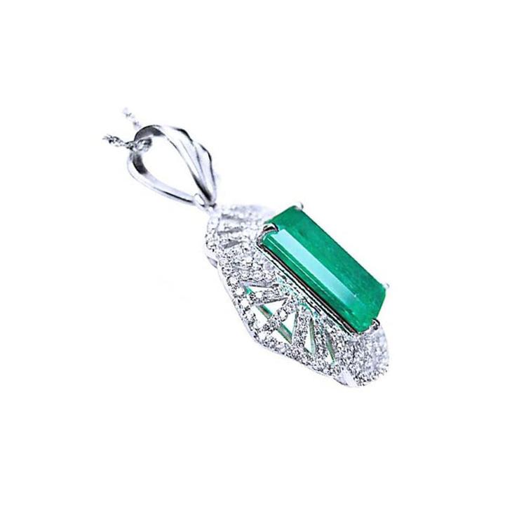 The underside view of a natural emerald-cut emerald pendant in white gold and accent diamonds.