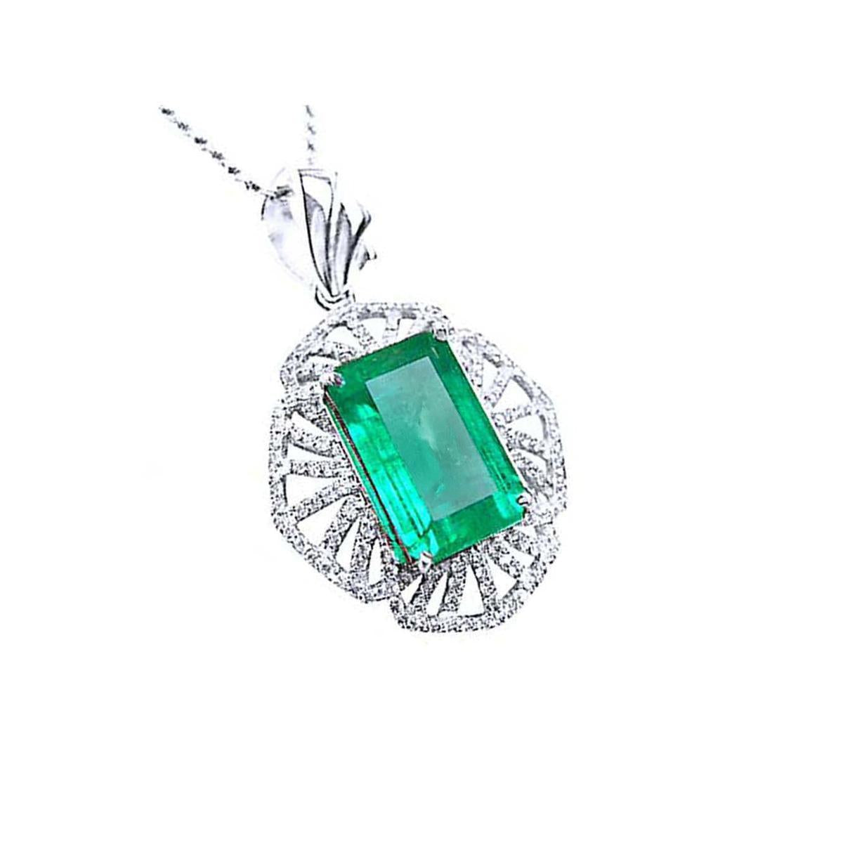 A natural colombian emerald-cut emerald pendant with diamond accents on a white gold design.