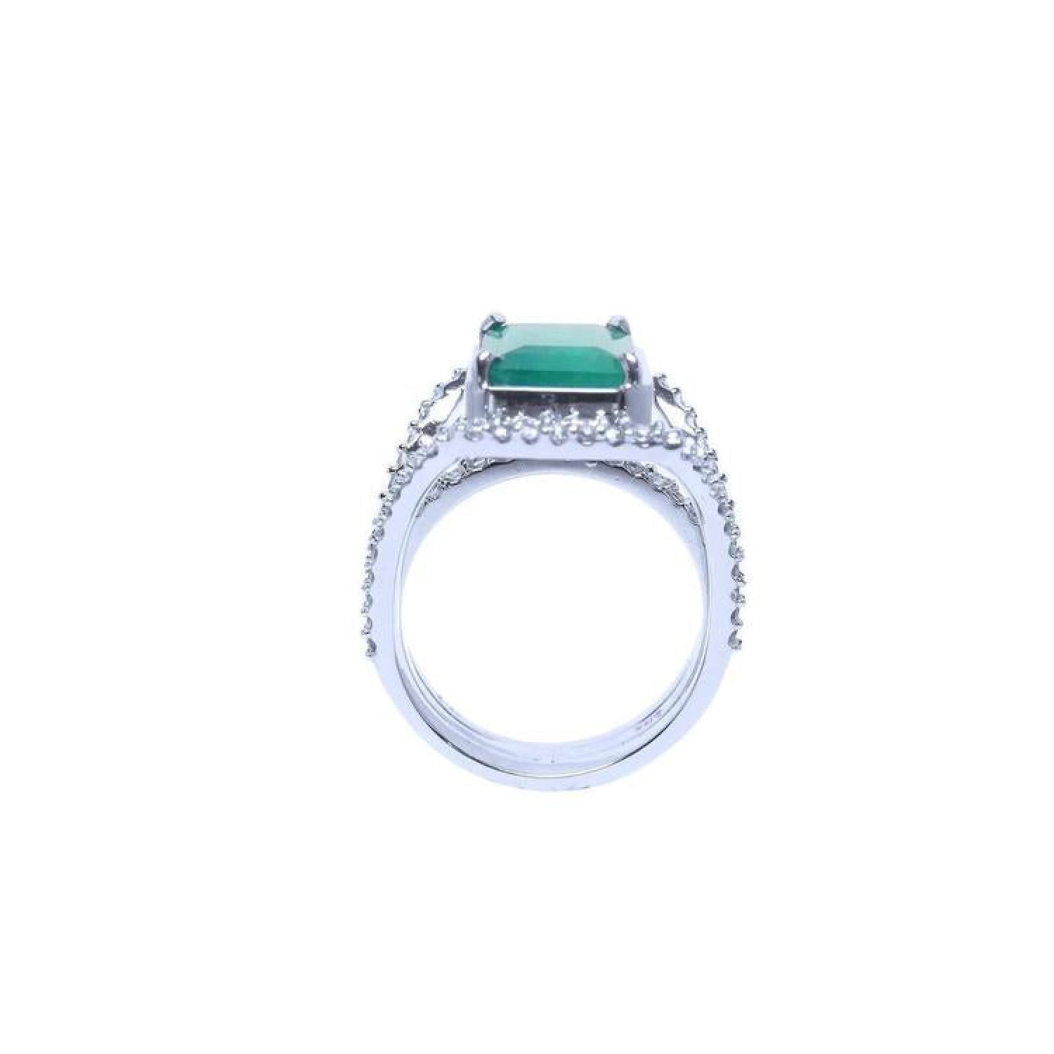 Emerald-cut 3.90 ct bluish-green natural emerald ring with triple row diamond band in 14K white gold.