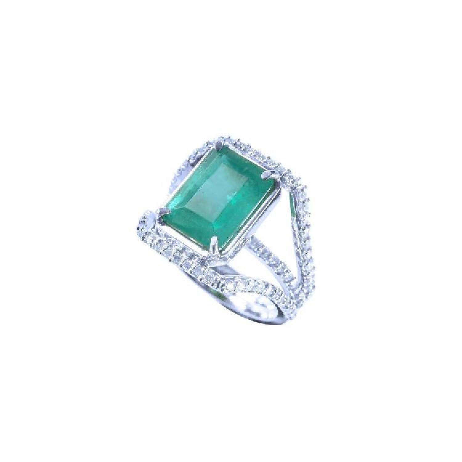 Emerald-cut 3.90 ct natural emerald ring with triple row diamond band in 14K white gold.