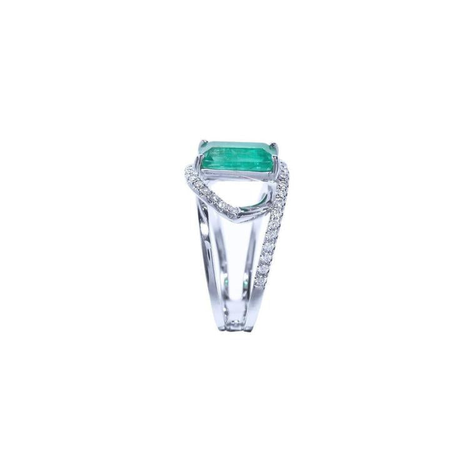 Rectangular emerald-cut emerald ring with diamond split shank in 14K white gold.