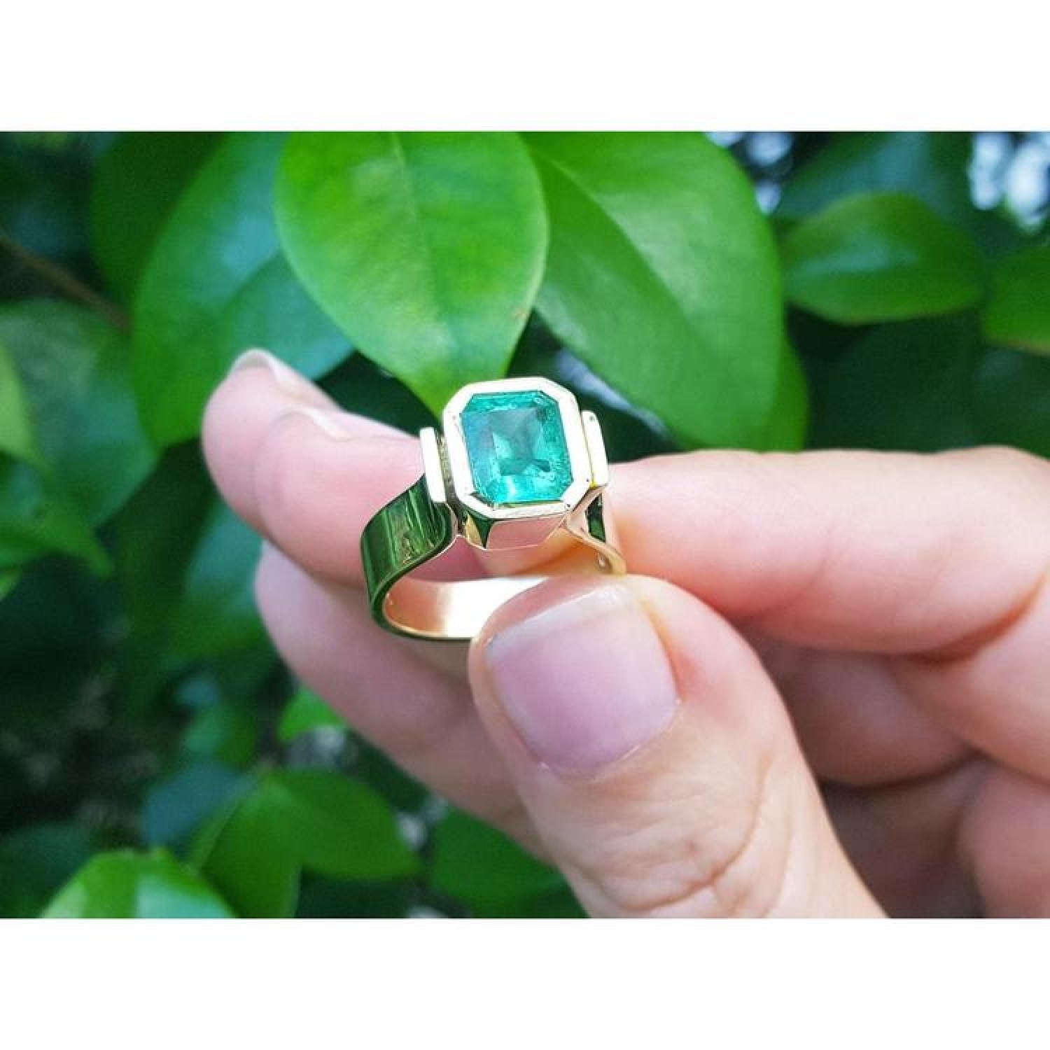 Emerald-cut emerald solitaire ring, 2.05 ct, bezel set in high polish 14K gold.