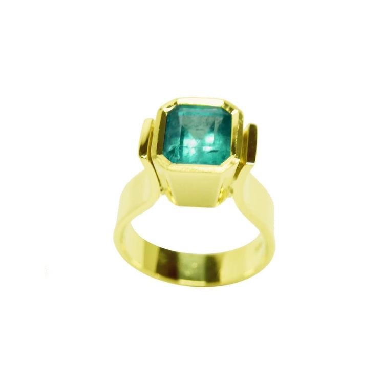 Emerald-cut emerald solitaire ring, bezel set in high polish 14K gold.