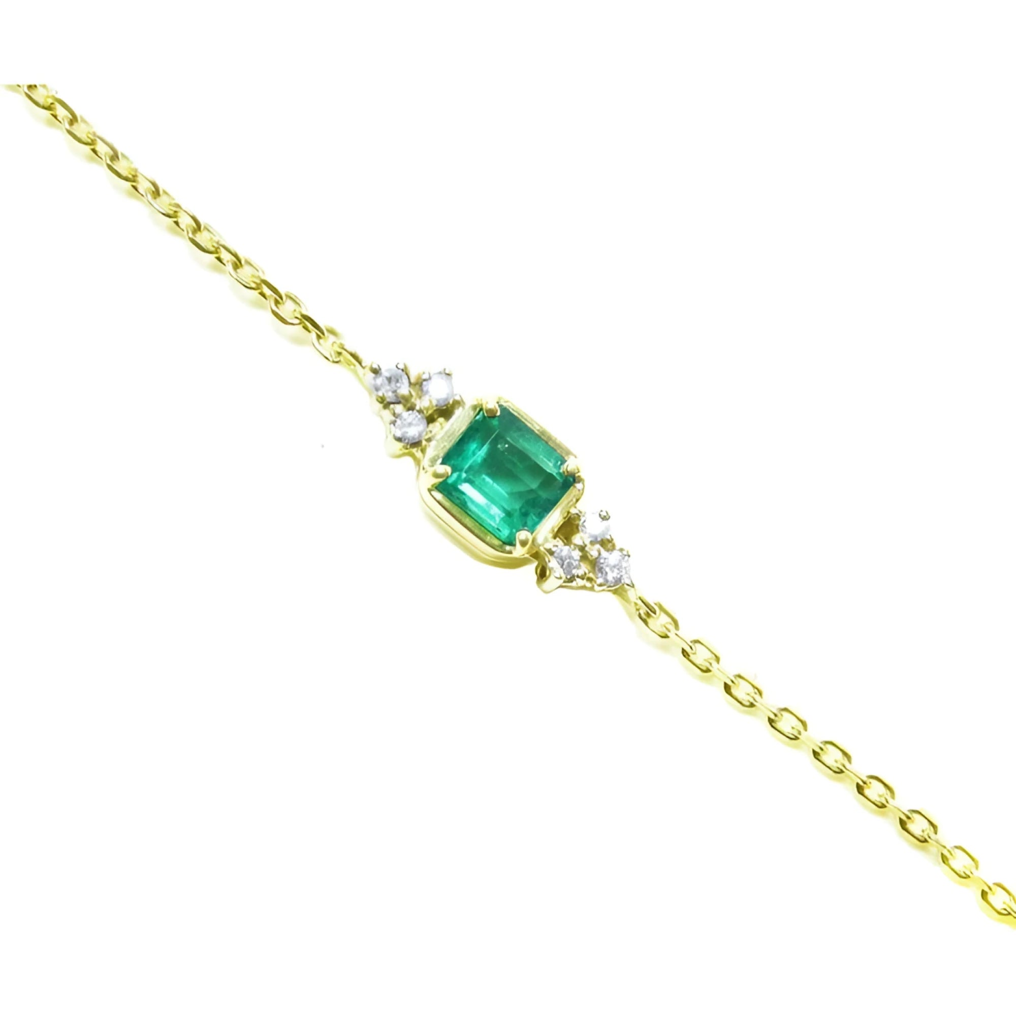 14k yellow gold bracelet with a 0.85 ct medium green emerald and six natural diamonds.