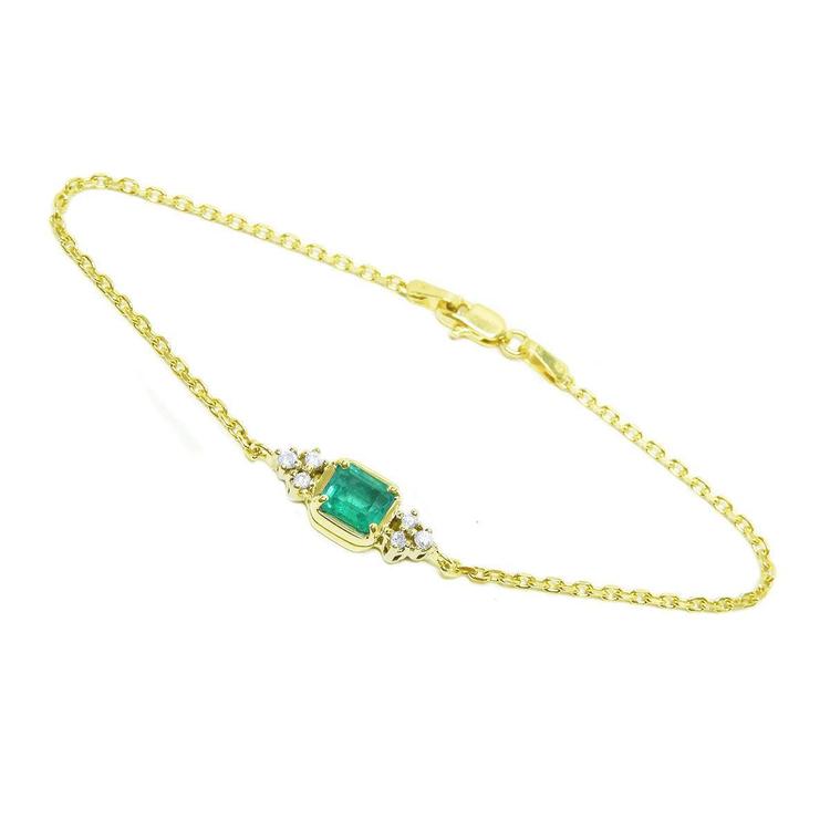 14k yellow gold emerald bracelet with a rectangular green emerald and six natural diamonds.