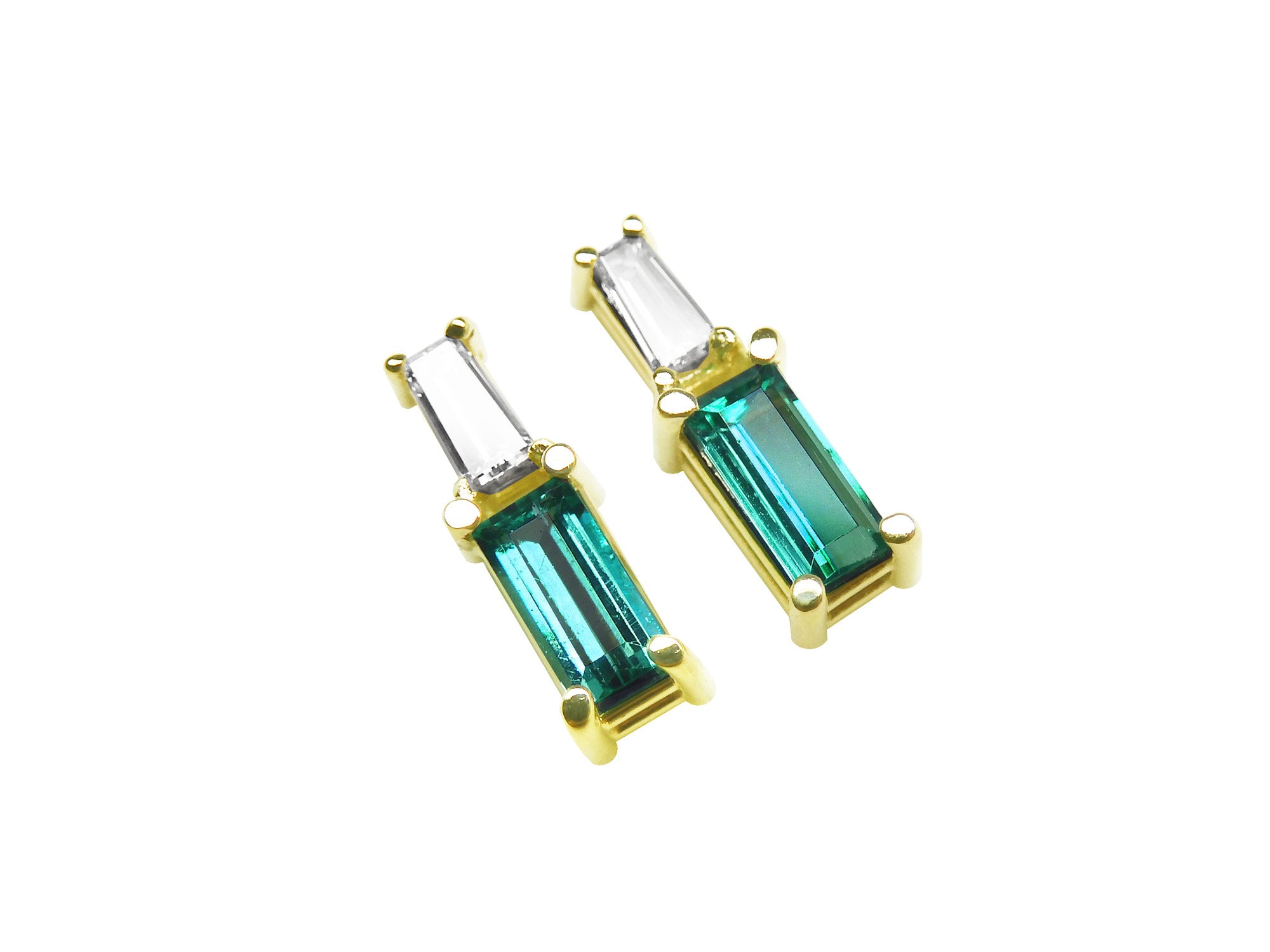 Pair of minimalist baguette cut emerald and diamond stud earrings, right side position top view.