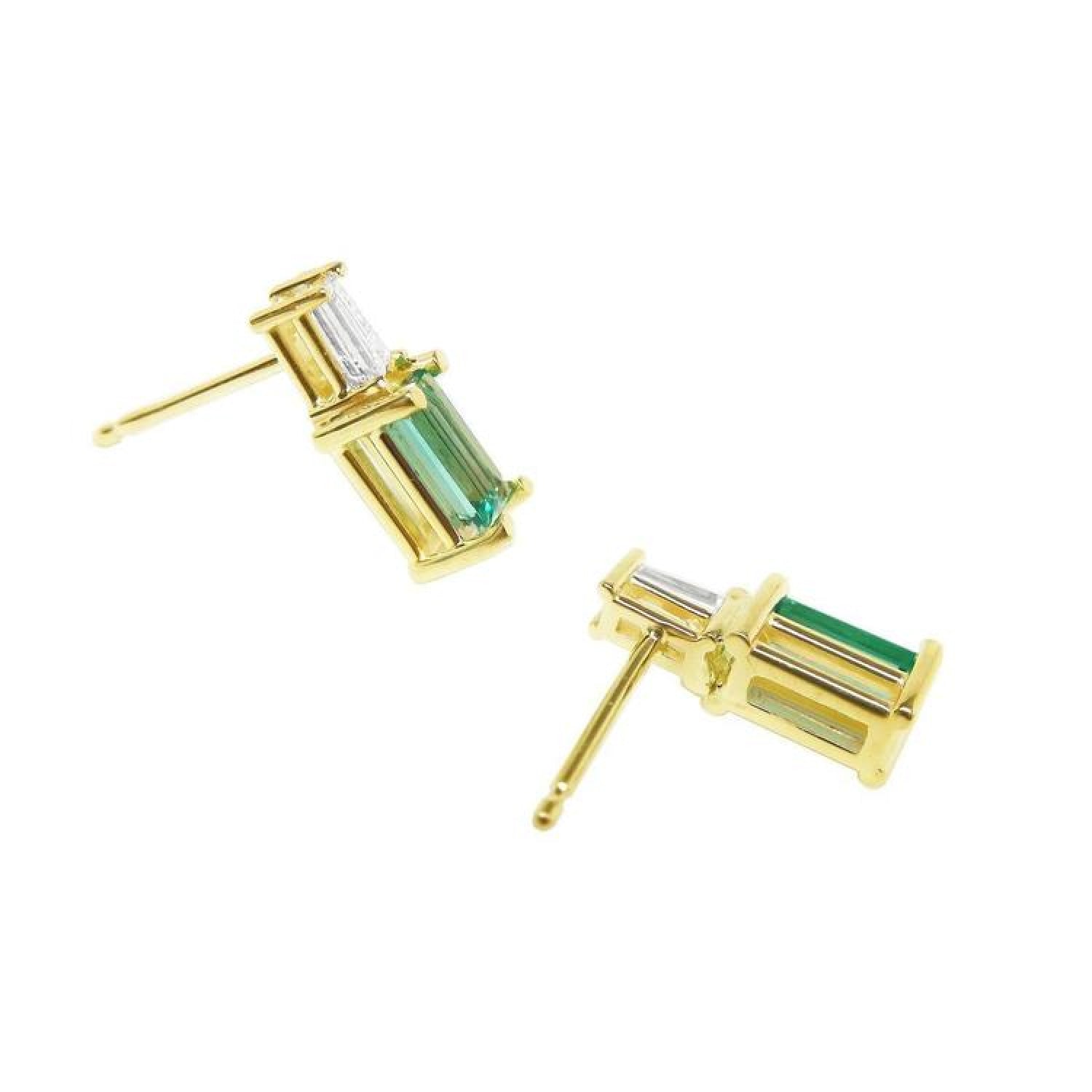 Gold stud earrings with baguette emeralds and tapered baguette diamonds.