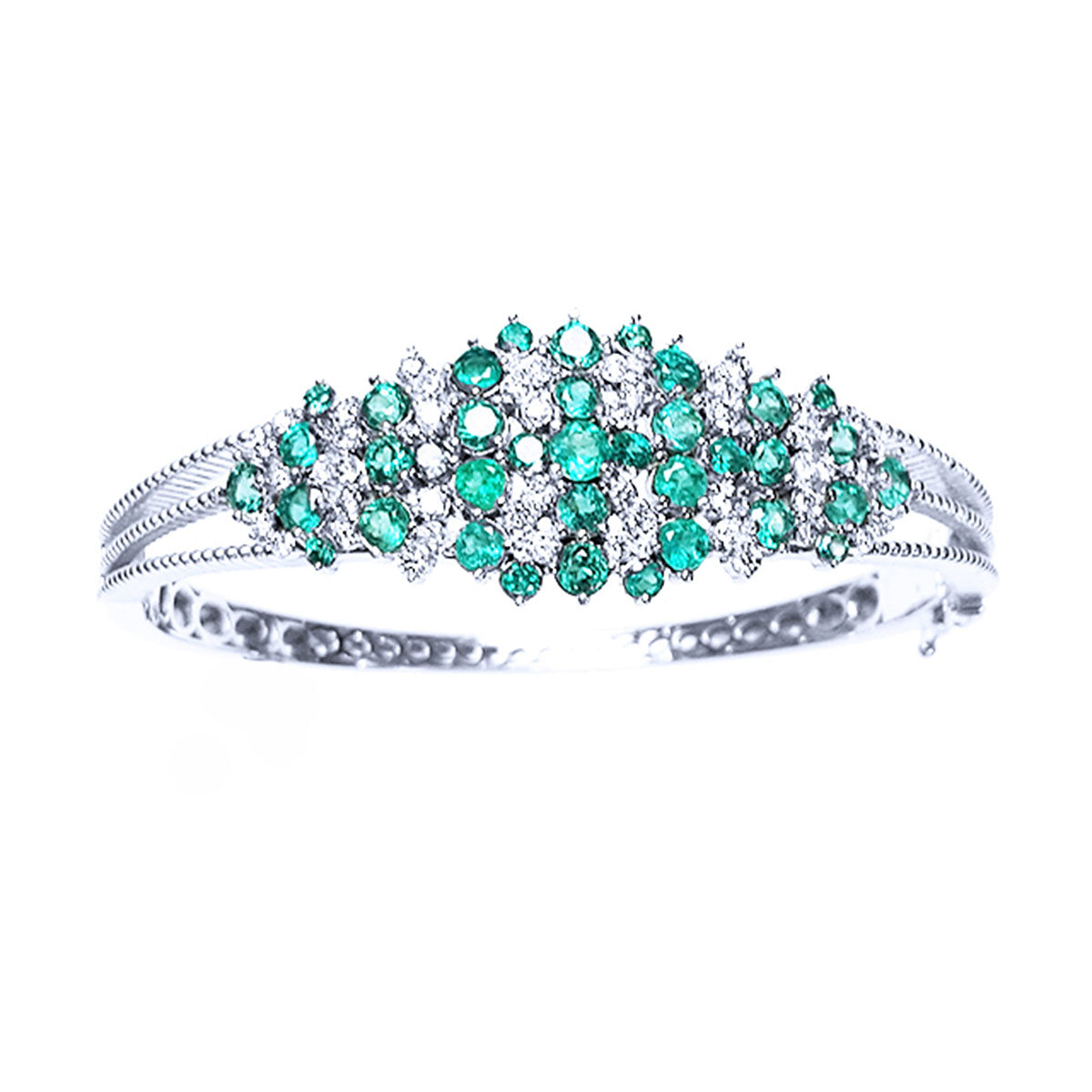 The topside profile of a white gold bangle bracelet with emeralds and diamonds on a white background.