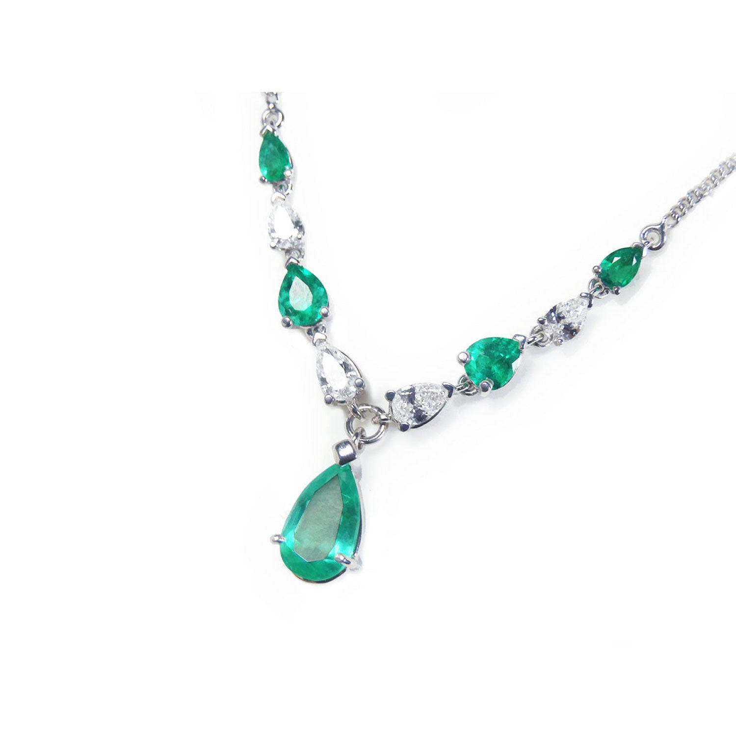 14k white gold necklace with pear-shaped emeralds and diamonds.