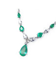 14k white gold necklace with pear-shaped emeralds and diamonds.