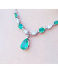Pear-shaped emerald and diamond necklace in 14k white gold, featuring a large emerald drop.