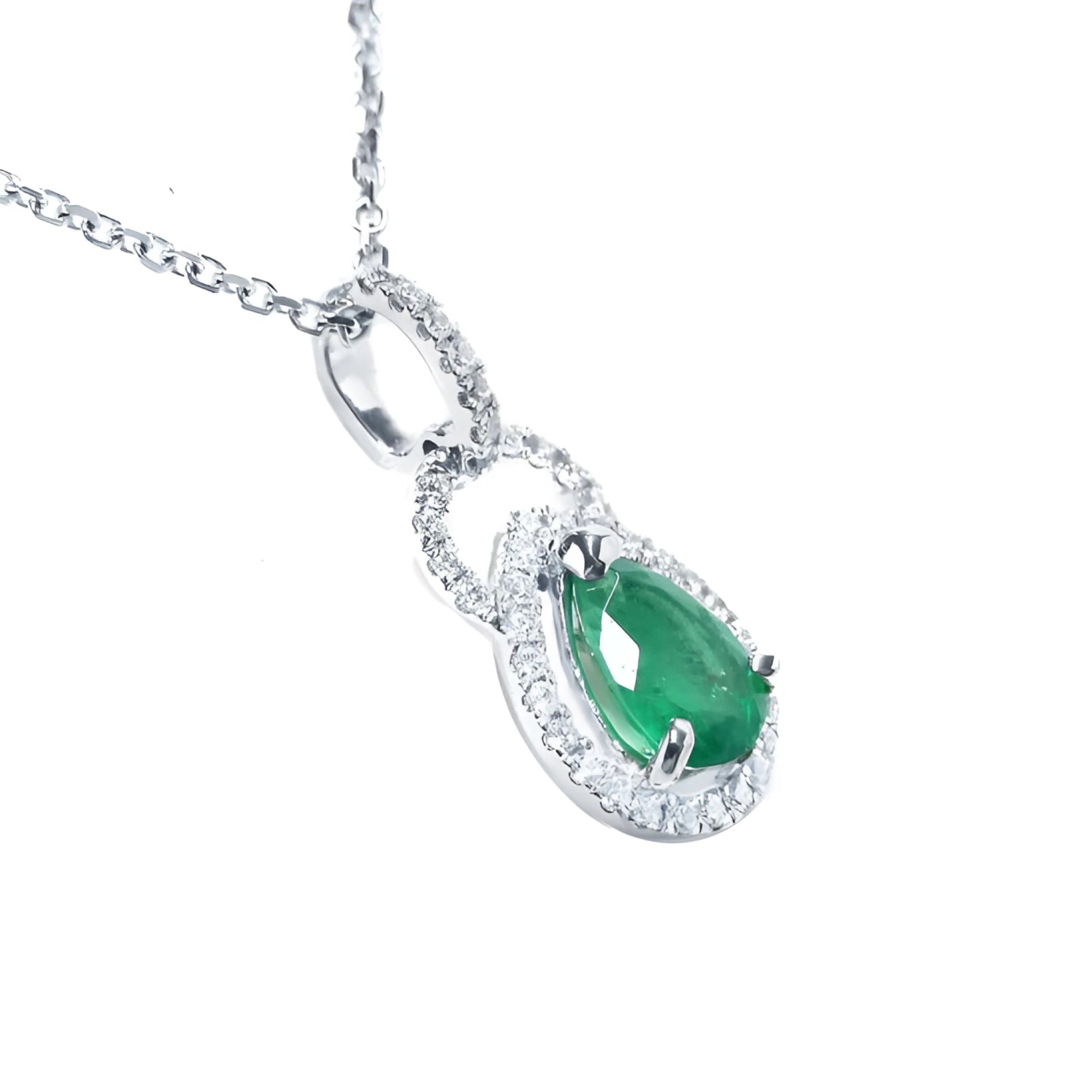 Pear-shaped Colombian emerald and diamond halo pendant in 14K white gold.