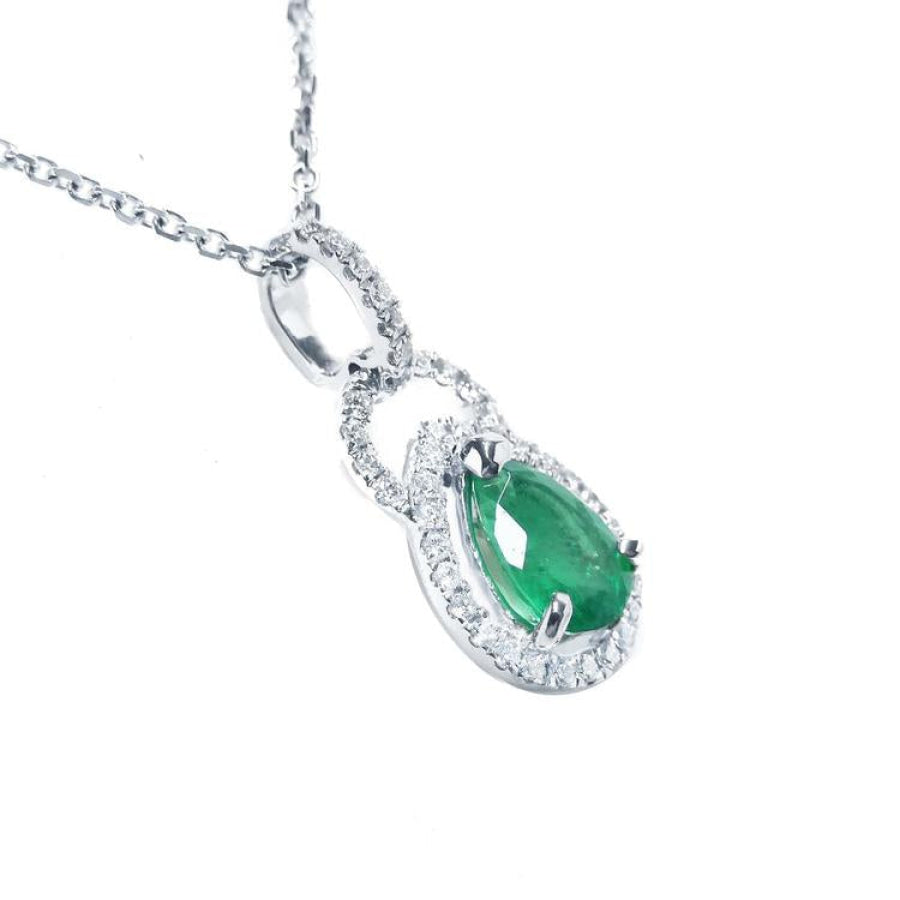 Pear-shaped Colombian emerald and diamond halo pendant in 14K white gold.