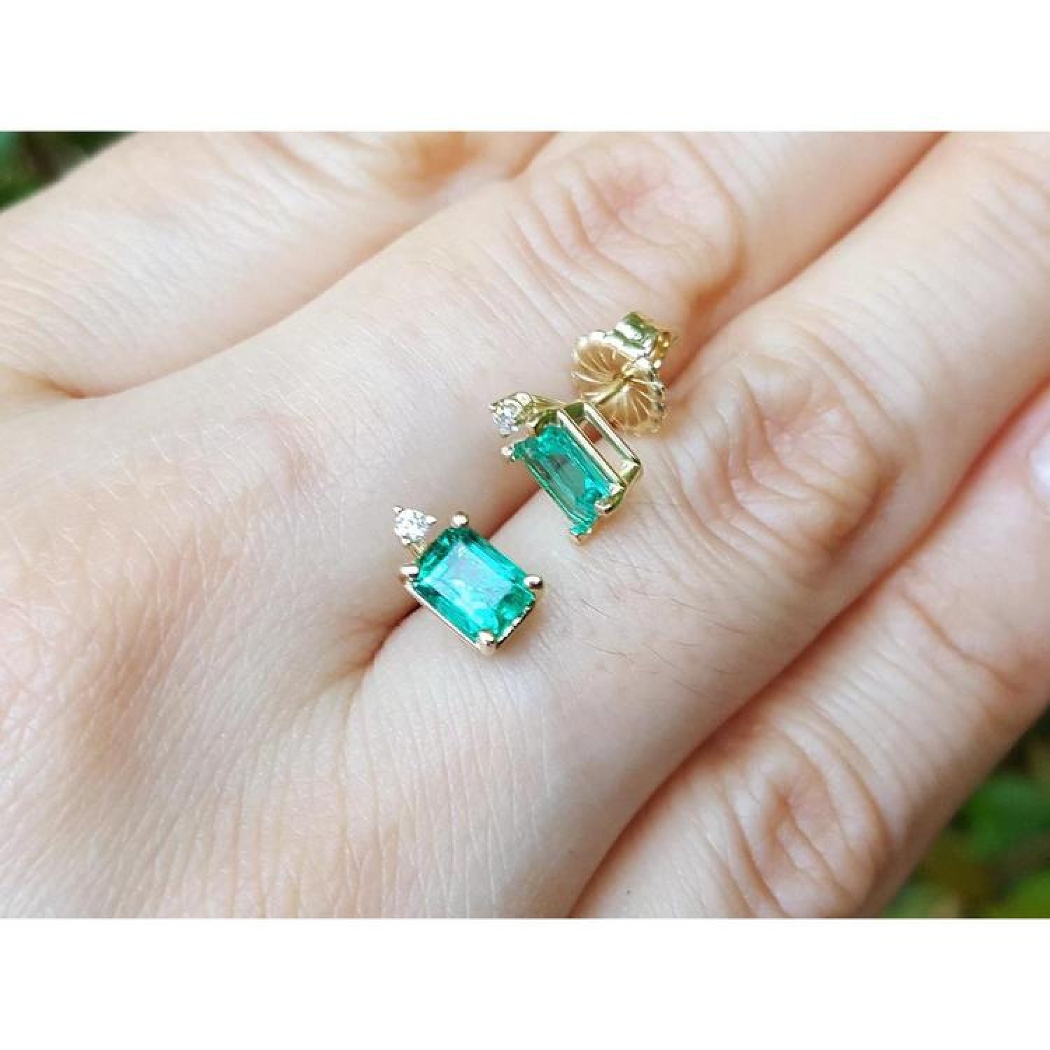 14K yellow gold stud earrings with rectangular Colombian emeralds and accent diamonds.