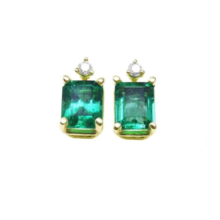 A pair of natural Colombian emerald stud earrings in 14k yellow gold.