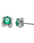 Pair of emerald and diamond tulip stud earrings on a front and underside view position.