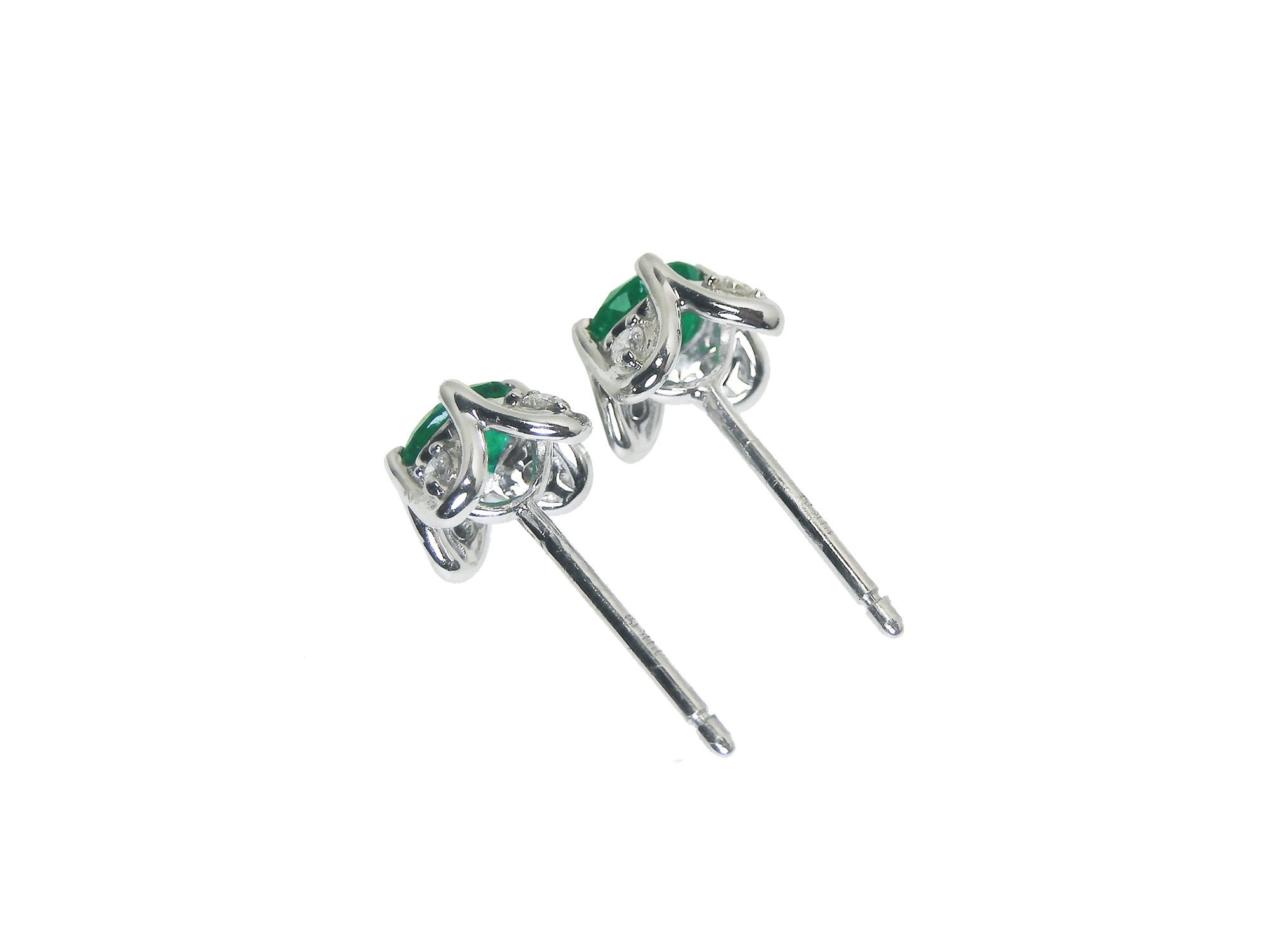 14k white gold Emerald and diamond tulip stud earrings, tilted position for an underside view.