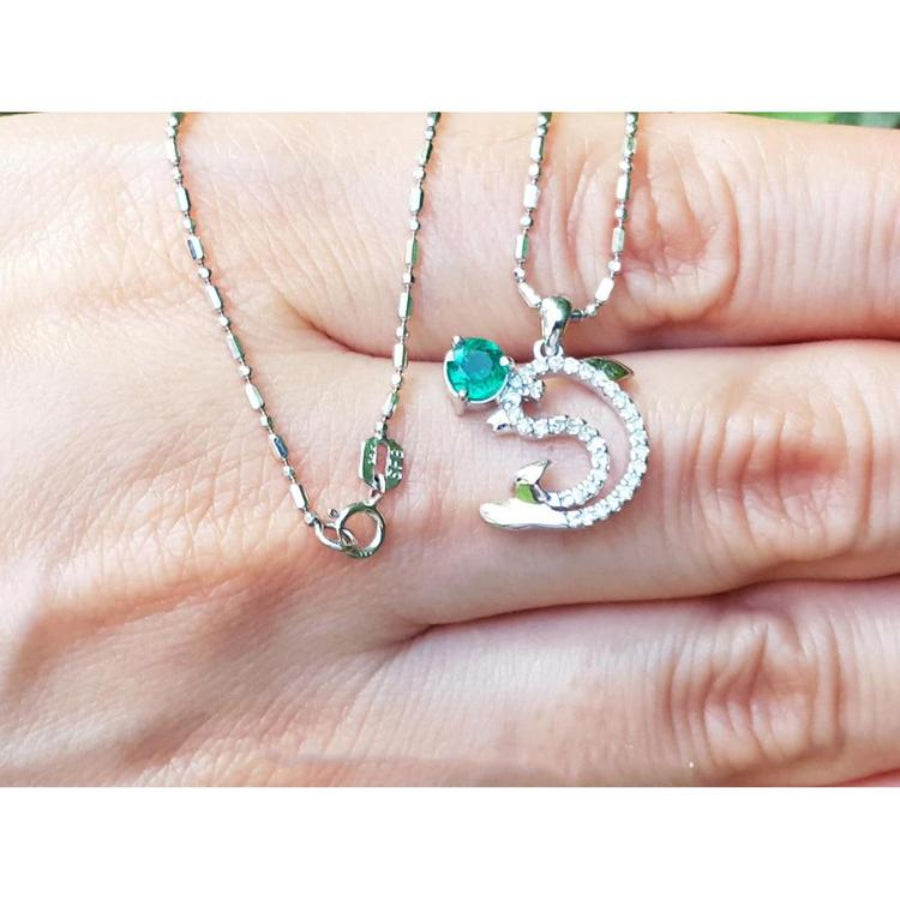 14K white gold dolphin pendant necklace with a round emerald and diamond accents.