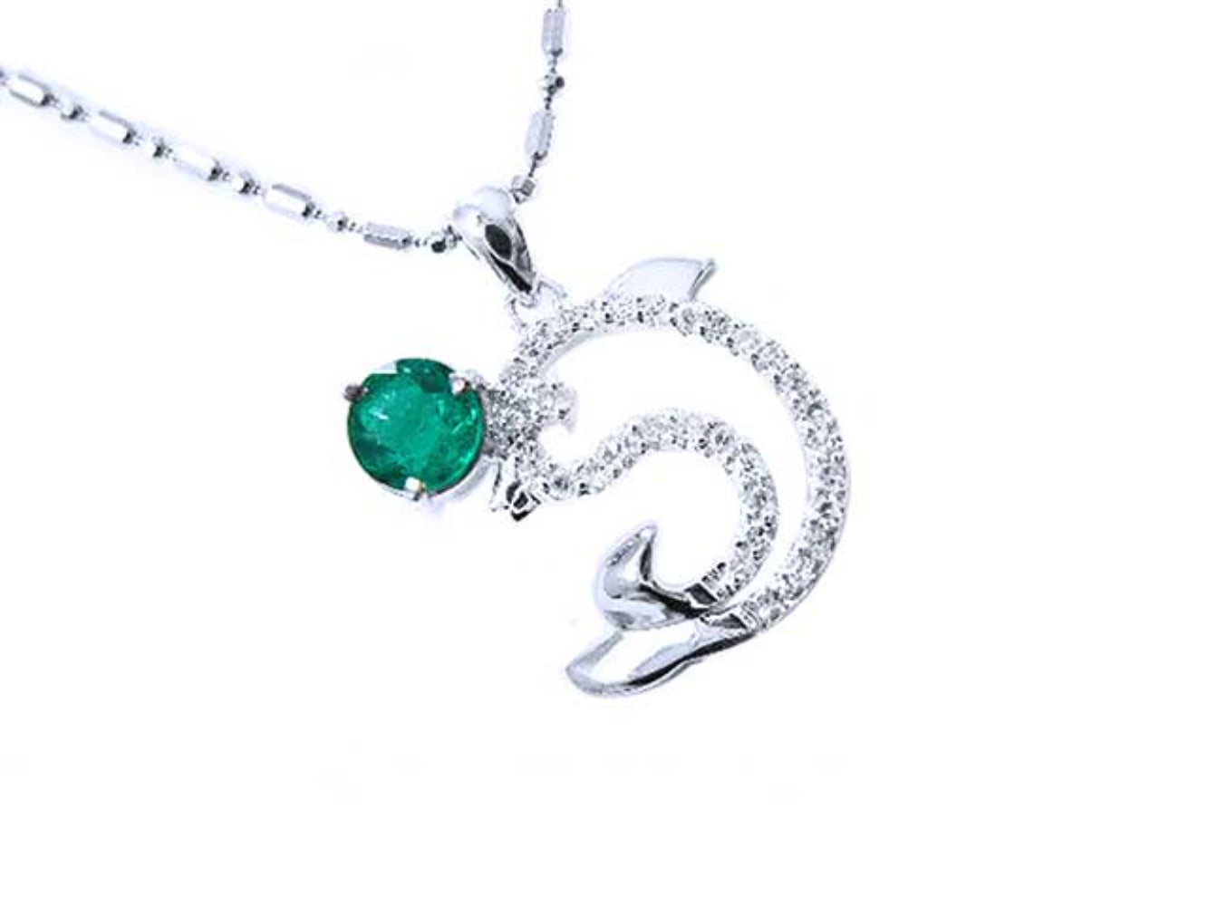 A solid white gold emerald dolphin pendant with natural diamonds.