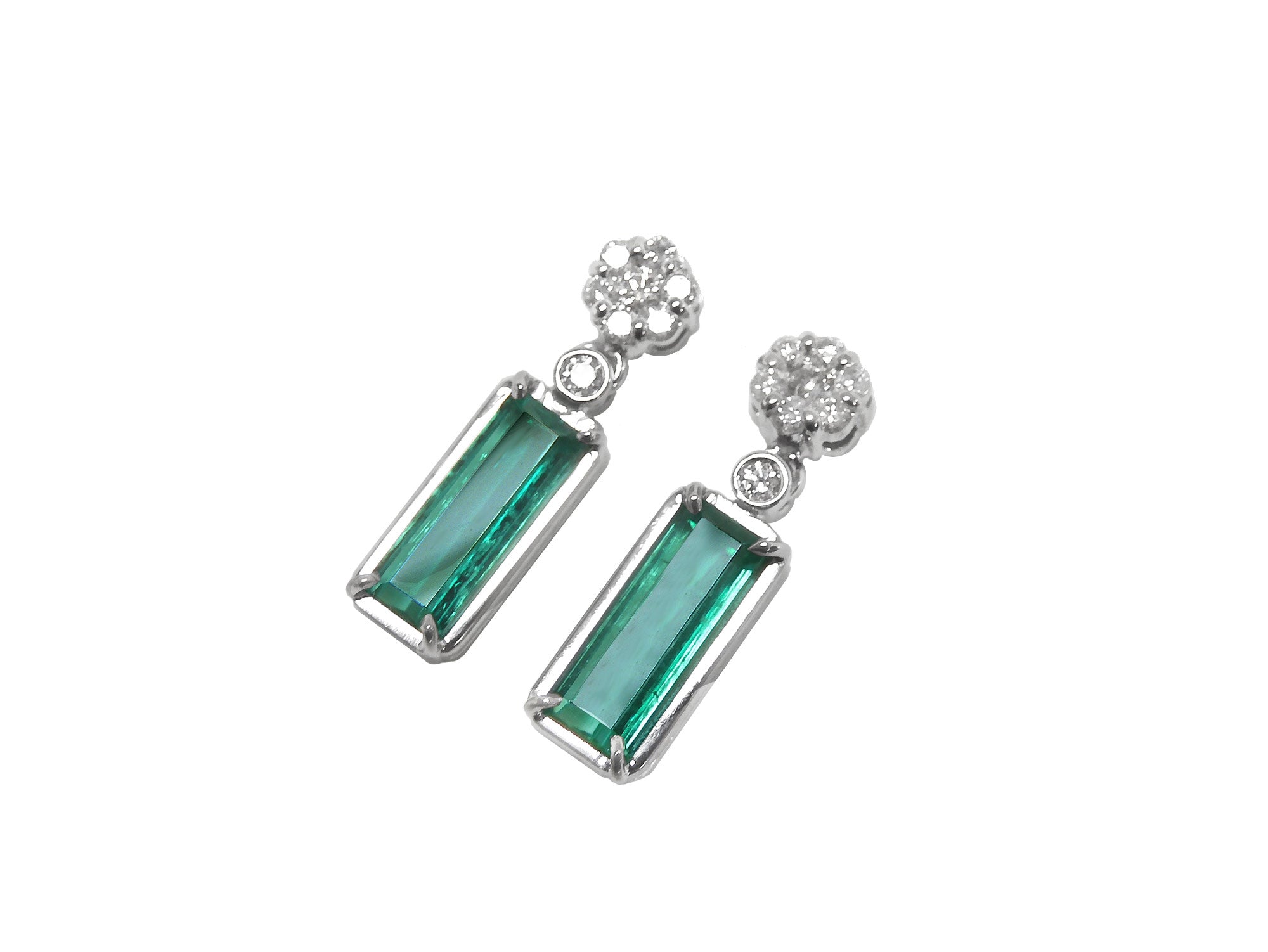 Left side position, top view of a pair of emerald earrings with a cluster diamond on top