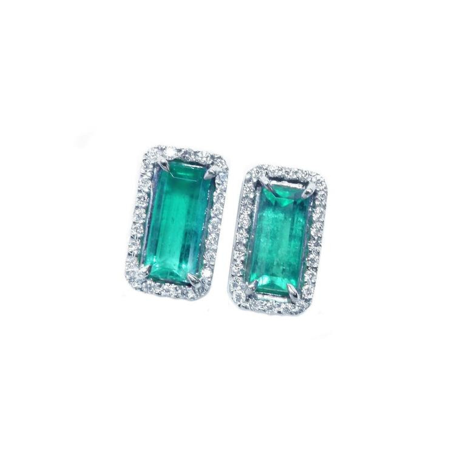 Emerald-cut Colombian emerald stud earrings with diamond halo in 18K gold.