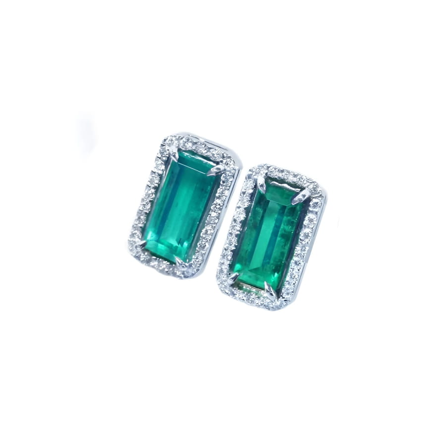 Sparkling rectangular emerald-cut stud earrings with diamond halos in 18K gold.