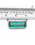 18K white gold Colombian emerald necklace with halo diamonds, East-West rectangular design, shown below a metal ruler for scale.