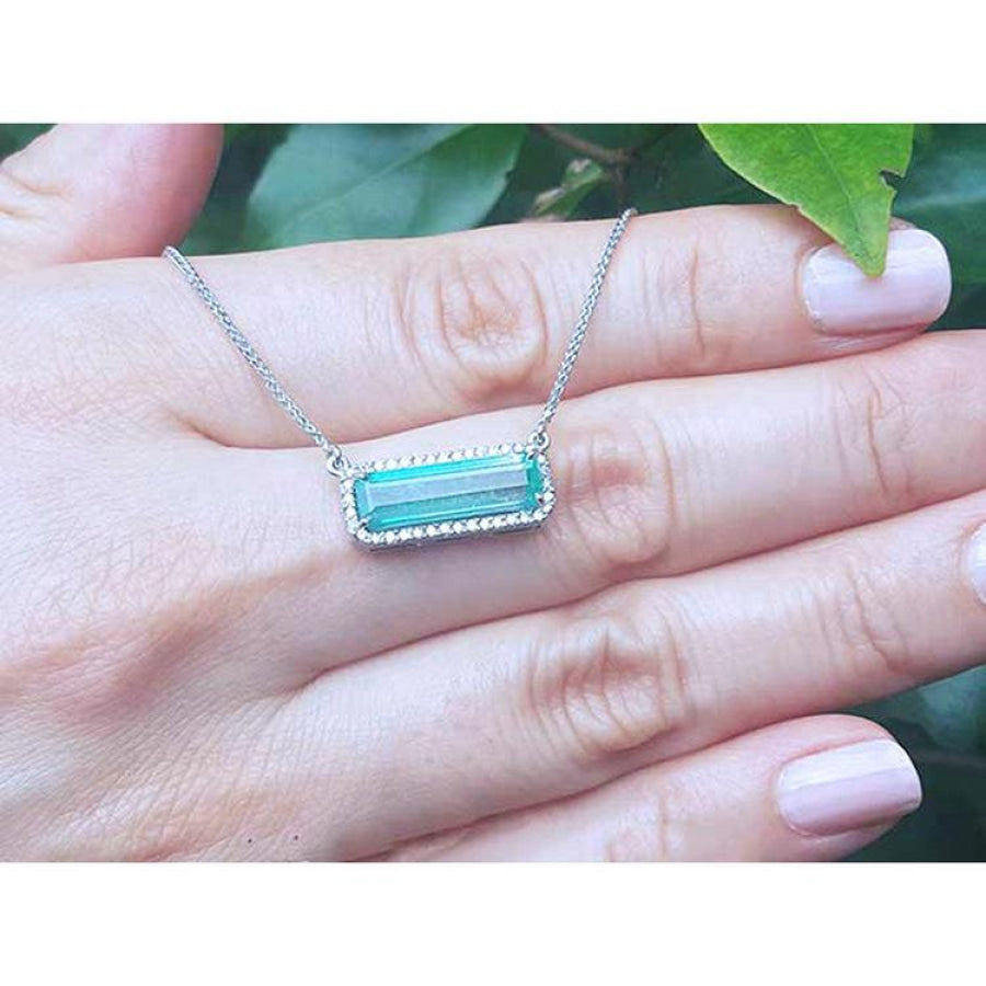 18K white gold necklace with a rectangular Colombian emerald and halo diamonds in an East-West design.
