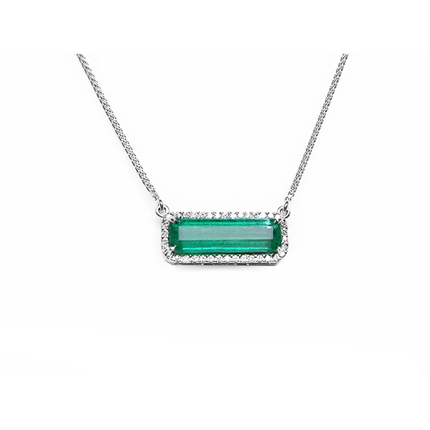 A natural emerald necklace white gold pendant, featuring a vibrant green emerald-cut center stone surrounded by a halo of diamonds, suspended from a delicate gold chain.