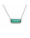 A natural emerald necklace white gold pendant, featuring a vibrant green emerald-cut center stone surrounded by a halo of diamonds, suspended from a delicate gold chain.