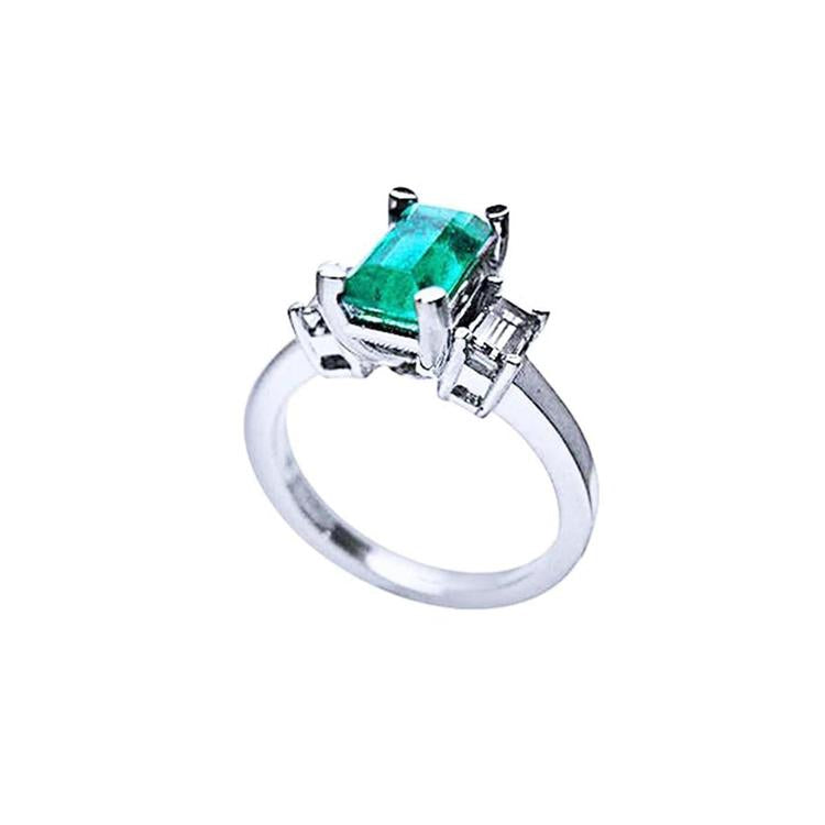 1.09 ct emerald cut Colombian emerald engagement ring in 18K white gold with baguette diamonds.