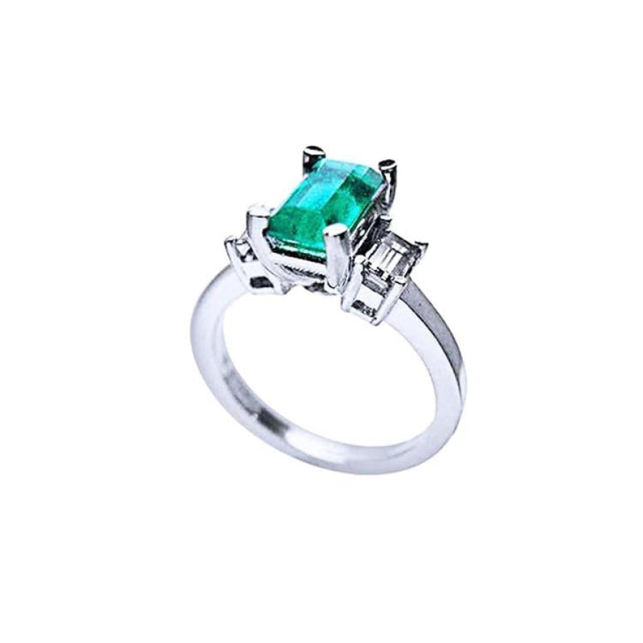 1.09 ct emerald cut Colombian emerald engagement ring in 18K white gold with baguette diamonds.