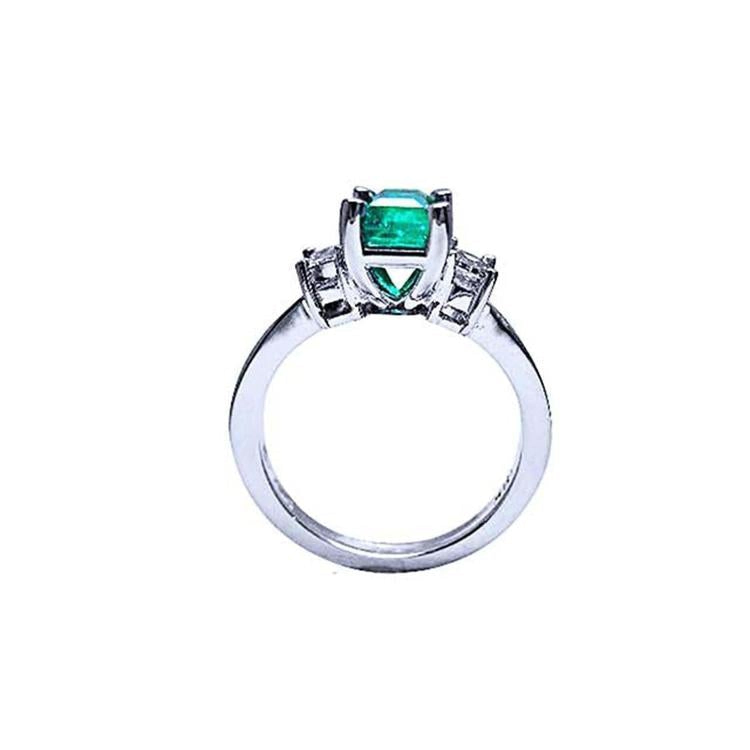 18K white gold engagement ring with a 1.09 ct emerald-cut Colombian emerald and baguette diamonds.
