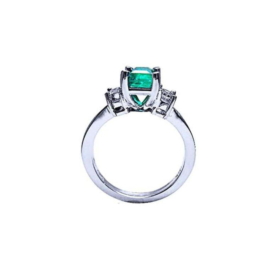 18K white gold engagement ring with a 1.09 ct emerald-cut Colombian emerald and baguette diamonds.
