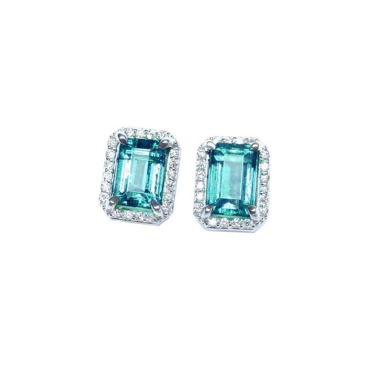 Pair of Colombian emerald stud earrings with halo diamond, front position, full top view.