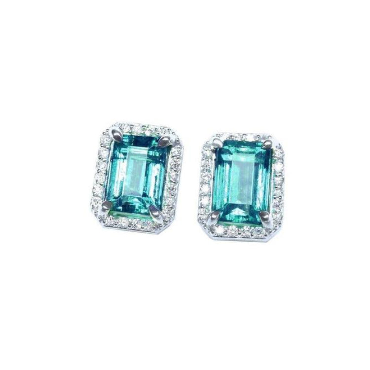 Pair of Muzo Colombian emerald stud earrings with halo diamond crafted in 14k white gold.