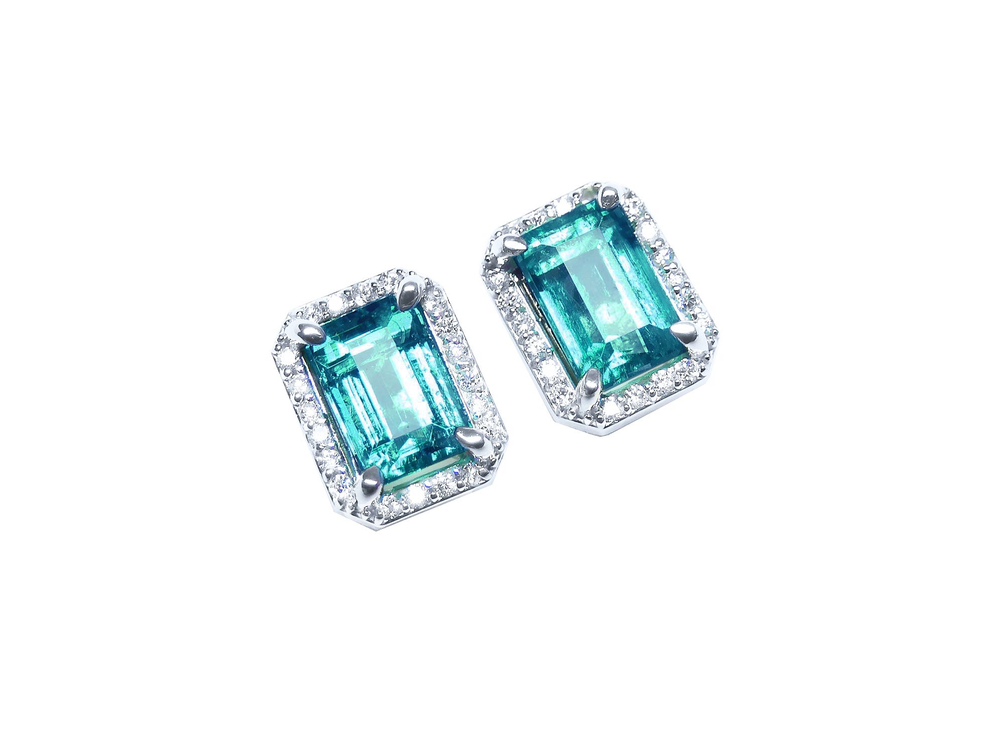 Pair of emerald-cut 14k gold Colombian emerald stud earrings with halo diamond on a right-side position top view.