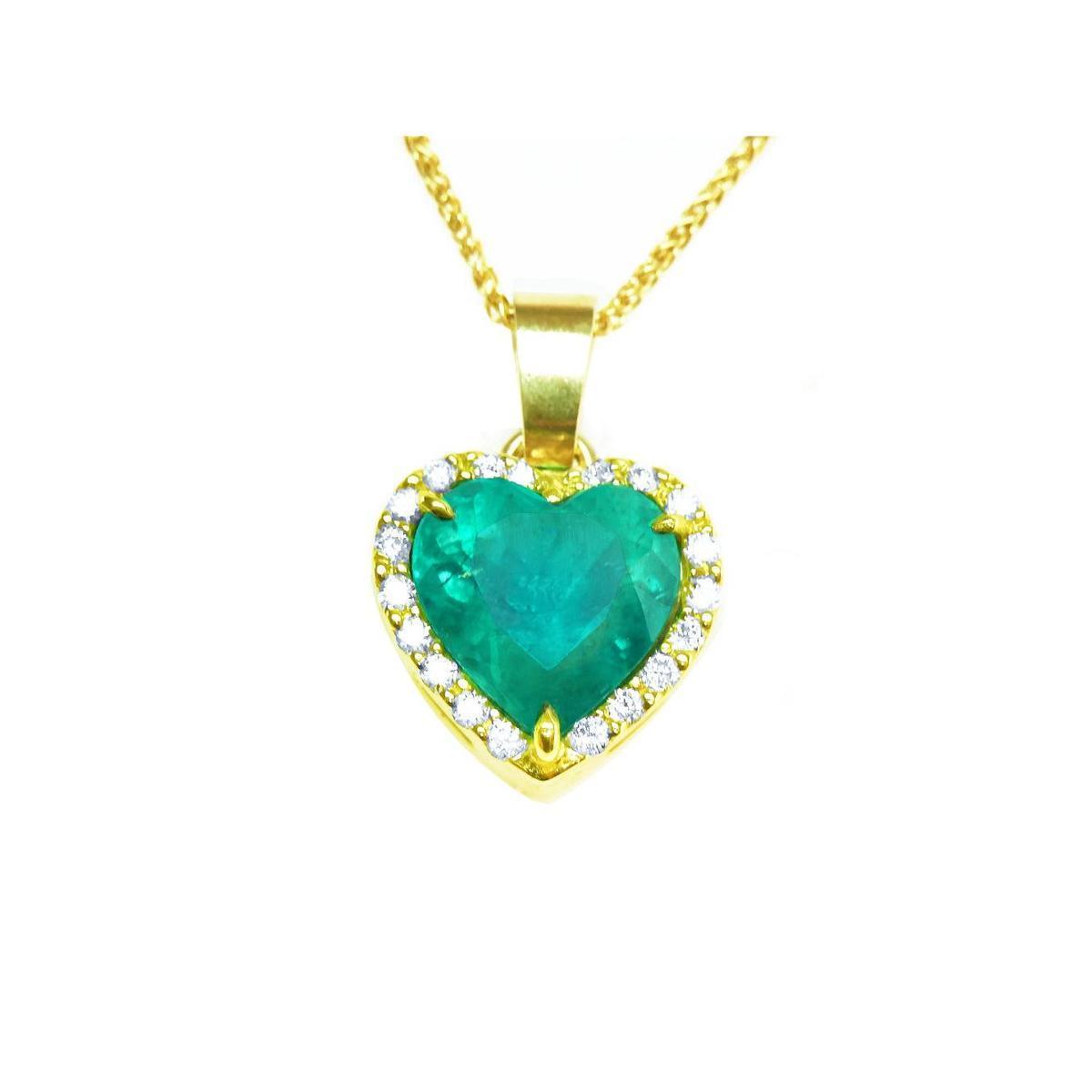 Heart-shaped emerald pendant with gold frame with diamonds and chain on toside view position.