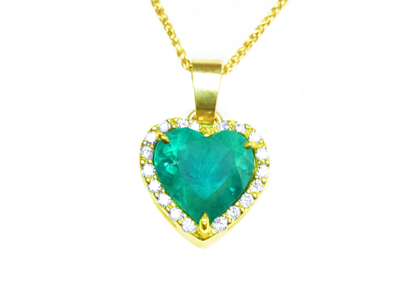 Heart-shaped emerald pendant with gold frame with diamonds and chain on toside view position.