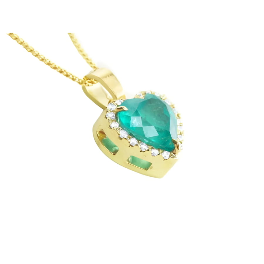 Heart-shaped emerald pendant with diamond halo in 18K yellow gold.