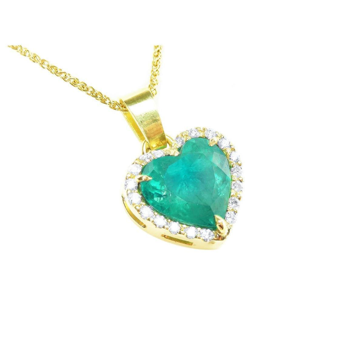 Gold necklace with a heart-shaped emerald pendant with a halo diamond on a topside view position.
