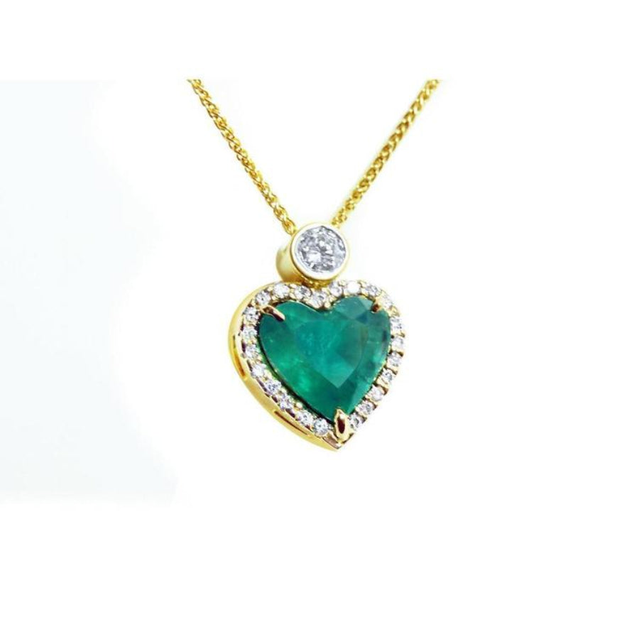 18k yellow gold heart pendant with a large bluish-green emerald haloed by diamonds on a delicate chain.