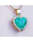 Heart-shaped emerald pendant with gold frame and diamonds made of 18k yellow gold.