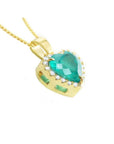 Heart-shaped emerald pendant with diamond halo in 18K yellow gold.