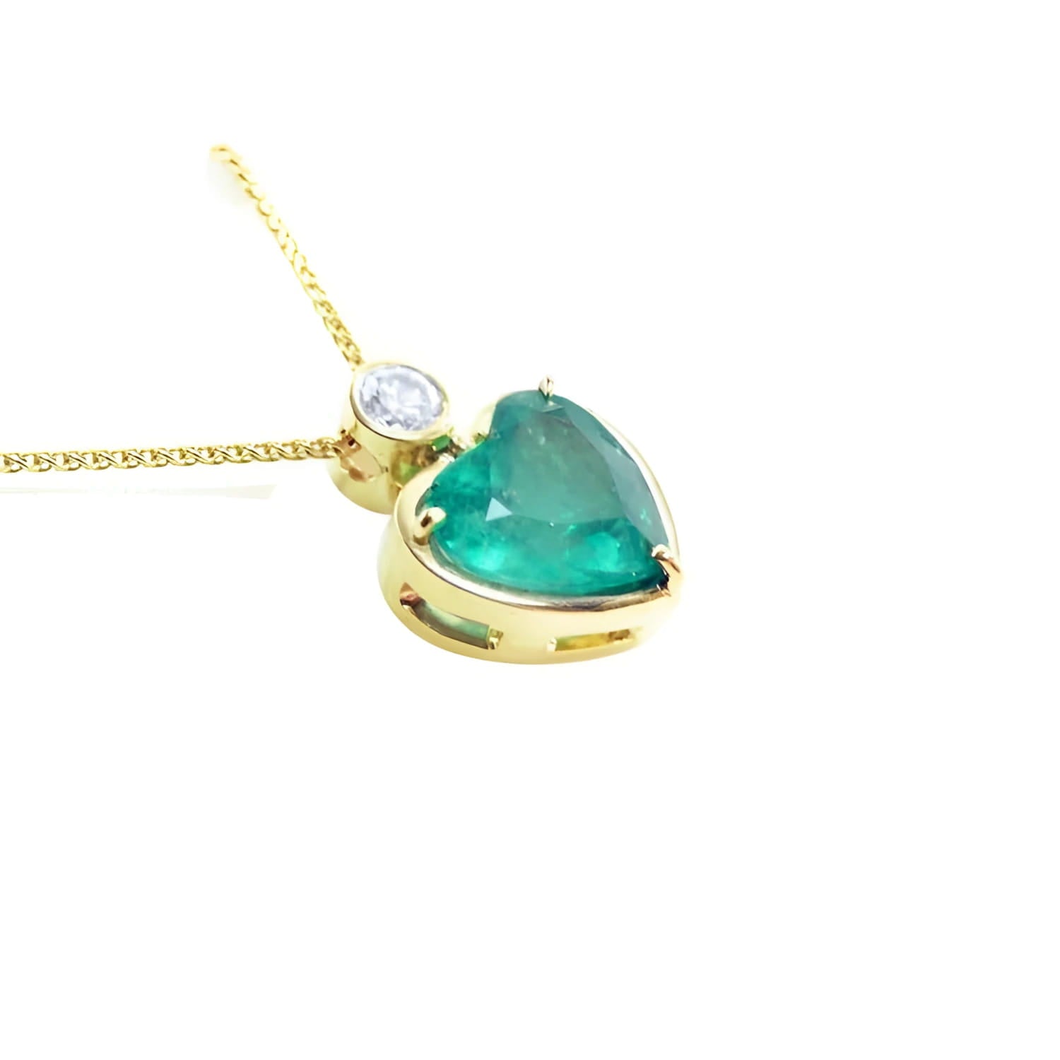 Heart-shaped emerald pendant in 18K yellow gold with a slider bail and bezel-set diamond.