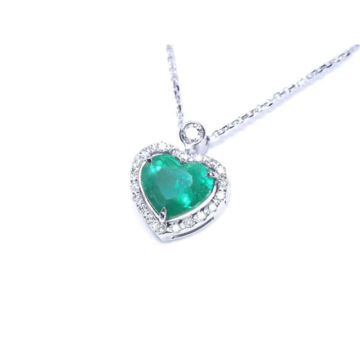 Natural emerald heart pendant in 14K white gold, framed by a halo diamond on a delicate chain.